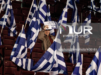 A supporter of Nea Dimokratia (New Democracy) party among Greek flags wait for Antonis Samaras' pre-election speech. Athens, January 23, 201...