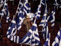A supporter of Nea Dimokratia (New Democracy) party among Greek flags wait for Antonis Samaras' pre-election speech. Athens, January 23, 201...