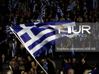 A Greek flag waves at Antonis Samaras' pre-election speech. Athens, January 23, 2015. (
