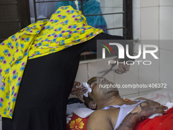 Nazmul Hossain's aunt cutting his hair which were burnt by  recent bomb attack in a bus and receives treatment at Dhaka Medical College Hosp...