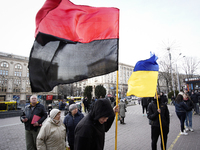 Youths are seen holding a Ukrainian flag and a Ukrainian Insurgent Army flag in central Kyiv, Ukraine on March 29, 2019. The red and black f...