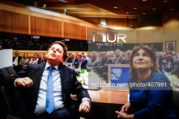 Dutch minsiter of foreign affairs Bert Koenders (L) and minister of foreign trade Lilianne Ploumen (R) are seen watching a film at the intro...