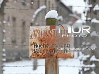 A view of the sign and fences outside the former Auschwitz 1 Camp, ahead of the 70th Anniversary of the Camp Liberation. Oświęcim, Poland. 2...
