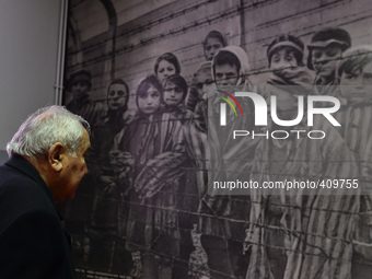 Auschwitz survivor, Mathias Hirsch from Switzerland looks at a picture that he can be seen on the third place from the right (la boy ooking...