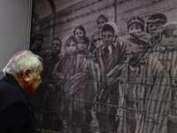 Auschwitz survivor, Mathias Hirsch from Switzerland looks at a picture that he can be seen on the third place from the right (la boy ooking...