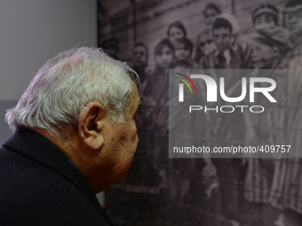 Auschwitz survivor, Mathias Hirsch from Switzerland looks at a picture that he can be seen on the second place from right, 70 years ago, as...