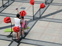 Tourists takes selfie with roses mock up, decorated by the shopping mall ahead for Valentine day in Bangkok, Thailand on January 31, 2015. T...
