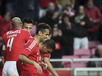 Benfica's defender Maxi Pereira (R) celebrates  with team mates after scoring a goal during the Portuguese League  football match between SL...