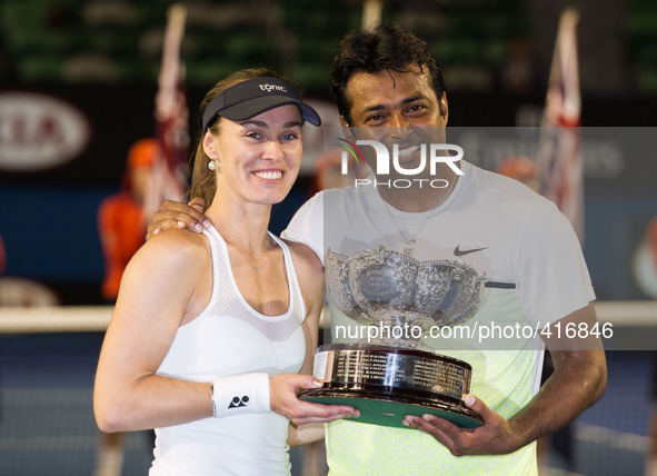MELBOURNE, Feb. 1, 2015 () -- Martina Hingis (L) of Switzerland and Leander Paes of India show their trophies after winning mixed doubles fi...