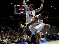 Real Madrid's Spanish player Sergio Llull  and Barcelona´s Croatian player Ante Tomic during the Basket Euroleague 2014/15 match between Rea...