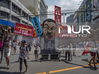 Protesters parade an effigy of Philippine President Rodrigo Duterte as they take part in Labor Day demonstrations outside the presidential p...