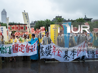 Protesters posing with banners and flags calling for more holidays, paid leave, more labour rights protections. During 2019 Labor Day March...
