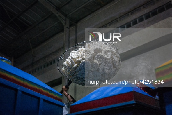 A man carries a basket full with kerupuk or crackers after frying them at a kerupuk factory in Depok, Indonesia, 01 May, 2019. Despite the g...