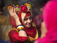 A Bangladeshi girl has her head decorated with flowers as they celebrate the arrival of spring on the first day of Falgoon at the Dhaka Univ...