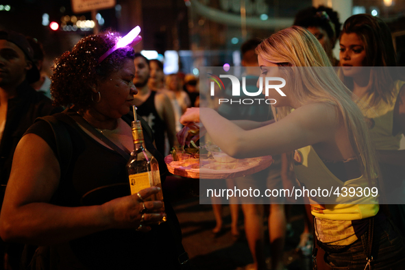 A woman drinks tequila on a Carnival parade in Augusta Street in Sao Paulo, Brazil on February 13, 2015. It is estimated that millions of pe...
