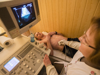 Sonographer doing ultrasonography for ATO soldier in Military Hospital, Ukraine. During Ukrainian-Russian conflict military hospitals overlo...