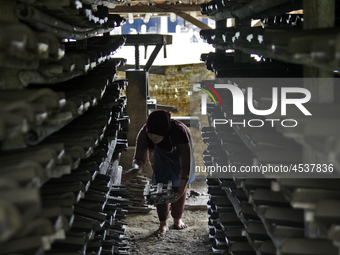 Female workers work on making tiles in clay tile factories at Pakuncen sub-district, Banyumas regency, Central Java province, on June 16, 20...
