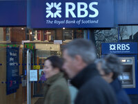 People walking past a branch of the Royal Bank of Scotland in Manchester on Wednesday 12th November 2014. -- The Royal Bank of Scotland (RBS...