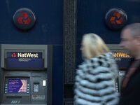 People walking past a Natwest cash machine in Manchester on Wednesday 12th November 2014. -- The Royal Bank of Scotland (RBS) trades as an i...