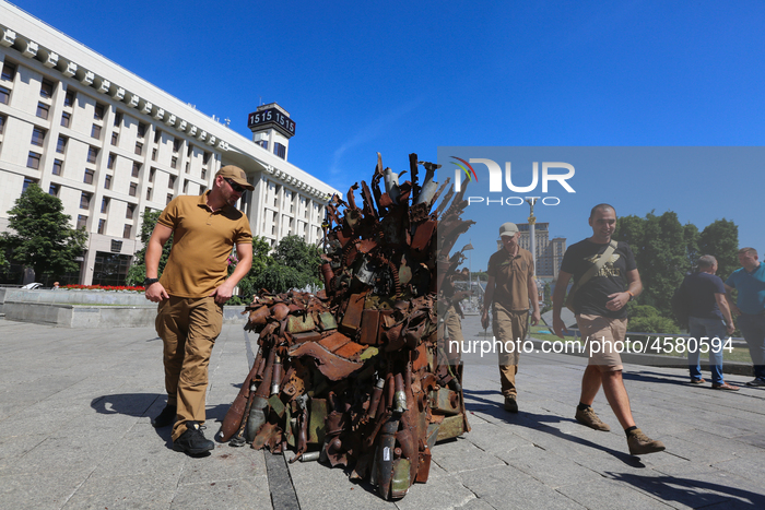 People look at the iron Throne installed at Independence Square in Kyiv,  Ukraine,  June 25, 2019. 
