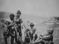 CRIMEA Balaclava -- 1855 -- Four men of the 77th East Middlesex Regiment of Foot standing and seated on the ground, holding rifles, wearing...