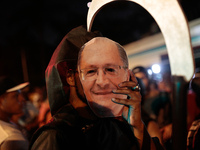 A demonstrator wears a maks of the governor of Sao Paulo, Geraldo Alckmin, during a protest in front ot the seat of the government of the st...