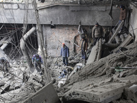 Ukrainian prisoners of war and emergency workers work in the ruins, extracting from the rubble the bodies of dead Ukrainian soldiers inside...
