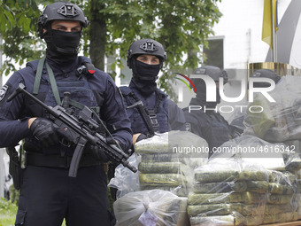 Ukrainian police officers stand guard in front of bags of cocaine seized during a special operation during a pess conference of the leadersh...