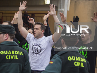 Animal rights activists is shout while they are being removed by the police after they jumped inside the arena to protest against bullfights...