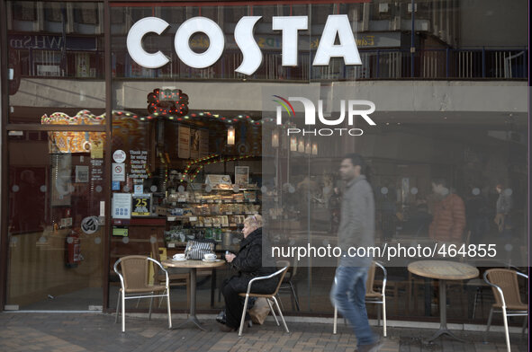 A person sitting outside a Costa Coffee in Stockport on Monday 2nd March 2015. 