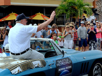  Astronaut Jerry Ross, a veteran of seven space shuttle missions, waves from a vintage Corvette in a parade with twelve other astronauts to...