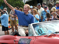  Former U.S. Sen. Bill Nelson (D-FL), a veteran of a space shuttle mission in 1986, waves from a vintage Corvette in a parade with twelve ot...