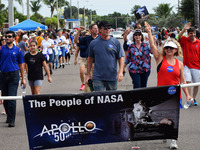  NASA employees march in a parade which included 13 astronauts to celebrate the 50th anniversary of the Apollo 11 moon landing on July 13, 2...