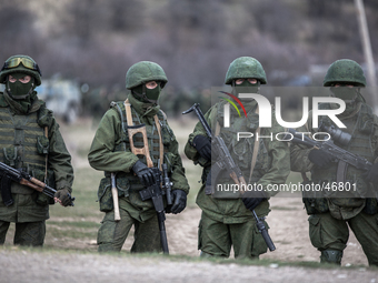 Alleged Russian soldiers in full body armor and armed with an assault rifles next to the besieged Ukrainian Military Base in Perevalnoye clo...