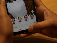 This illustration picture shows a user tries to edit her photo on FaceApp application on a smartphone (