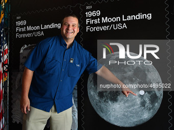 Greg Revera, an Alabama attorney, points to his photograph of the moon which was selected by the U.S. Postal Service for one its two new com...