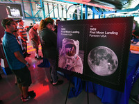 People wait in line to purchase two new commemorative 1969: First Moon Landing Forever stamps issued by the U.S. Postal Service to celebrate...