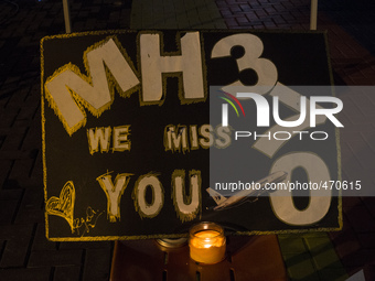 A candle is placed near a board for an event of the missing Malaysian Airlines MH370 in Petaling Jaya near Kuala Lumpur, Malaysia 6 March 20...