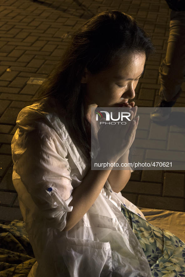 Kelly Wen, wife of a missing passenger prays as she take part in an event for the missing Malaysian Airlines MH370 in Petaling Jaya near Kua...