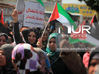 Palestinian women shout slogans during a march on the occasion of International Women's Day in Gaza City at the Unknown Soldier Square, in G...