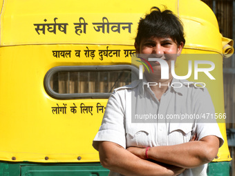 Sunita Chaudhary is one of Delhi's only female auto rickshaw drivers give pose to the camera on the eve of International Women's Day in Delh...
