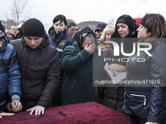Funerals of a coal miners who was killed in a mine collapse at Zasyadtko mine, is laid in rest during his funeral, on March 6, 2015 in Donet...