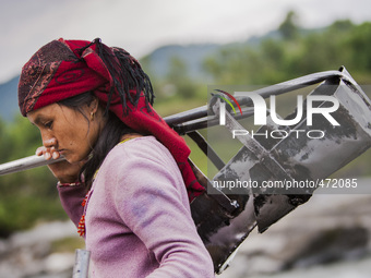 Woman with her tools for sand extraction in the Seti river close to Pokhara, Nepal. (