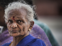 Old woman portrait while waits  for entering in a temple in Agra, India. (