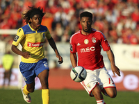 Benfica's Portuguese defender Eliseu (R) in action with Arouca's Belgian forward Joris Kayembe (L) during the Premier League 2014/15 match b...