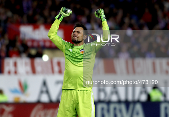 Valencia's Brazilian goalkeeper Diego Alves celebrates a goal during the Spanish League 2014/15 match between Atletico de Madrid and Decembe...