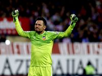 Valencia's Brazilian goalkeeper Diego Alves celebrates a goal during the Spanish League 2014/15 match between Atletico de Madrid and Decembe...