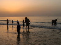 Palestinians enjoy the Gaza beach at sunset, on March 9, 2015. (