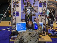 Woman in the parachute jump simulator in the spanish army stand during the security fair HOMSEC in Madrid, Spain, on March 10, 2015.(