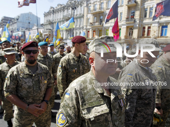Ukrainian servicemen, veterans of the Eastern Ukrainian conflict with Russia-backed separatists, march during a many-thousand unofficial mil...